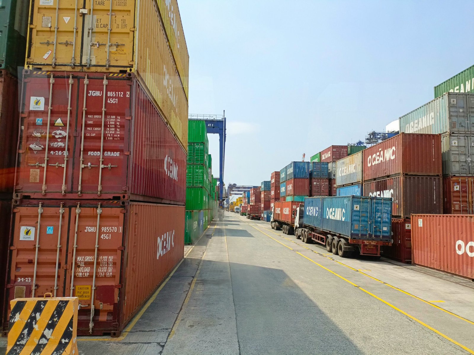 a long line of shipping containers on the side of a road